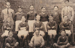 Gordon Snaith, is on the right in the middle row, standing in front of the man wearing glasses.